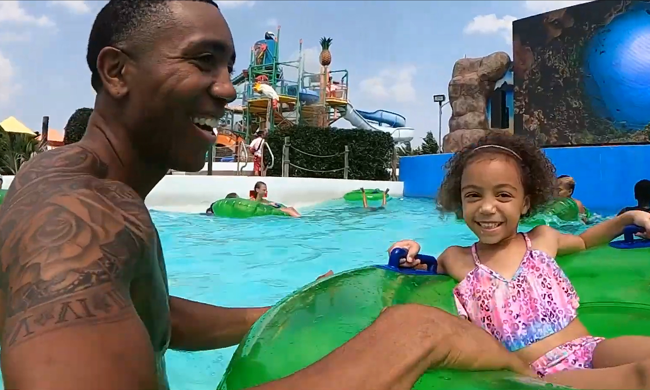 Father and daugher in splash pool